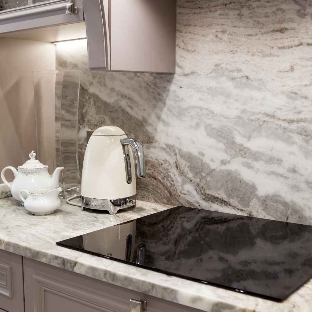 UV-stable, scorch-proof, only 6–12 mm thick. The right answer for outdoor kitchens and full-height slab walls.